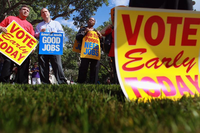 People listen during a get out the vote rally put on by local unions and Democratic politicians on the grounds of the Jackson Memorial hospital on October 18, 2010 in Miami, Florida.